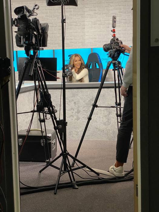 Camera crew filming a podcast set